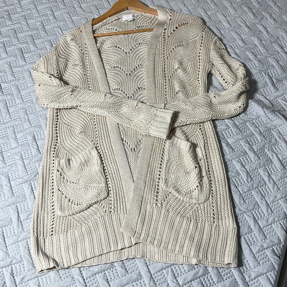 Knitted tan cardigan with beautiful pattern.